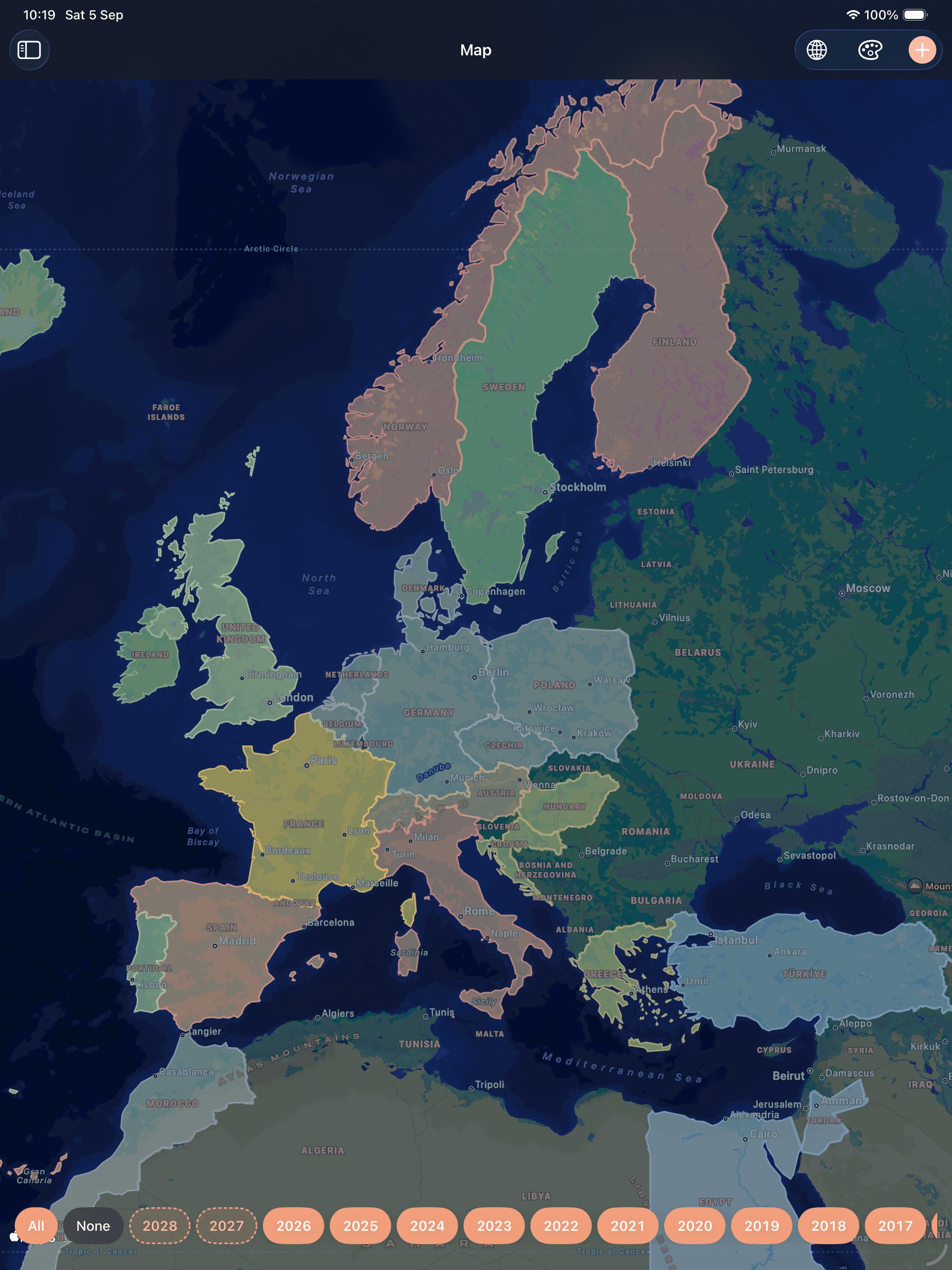 Europe after dark on Apple's own map, seas and city names showing through, each visited country tinted in the colour of its year.
